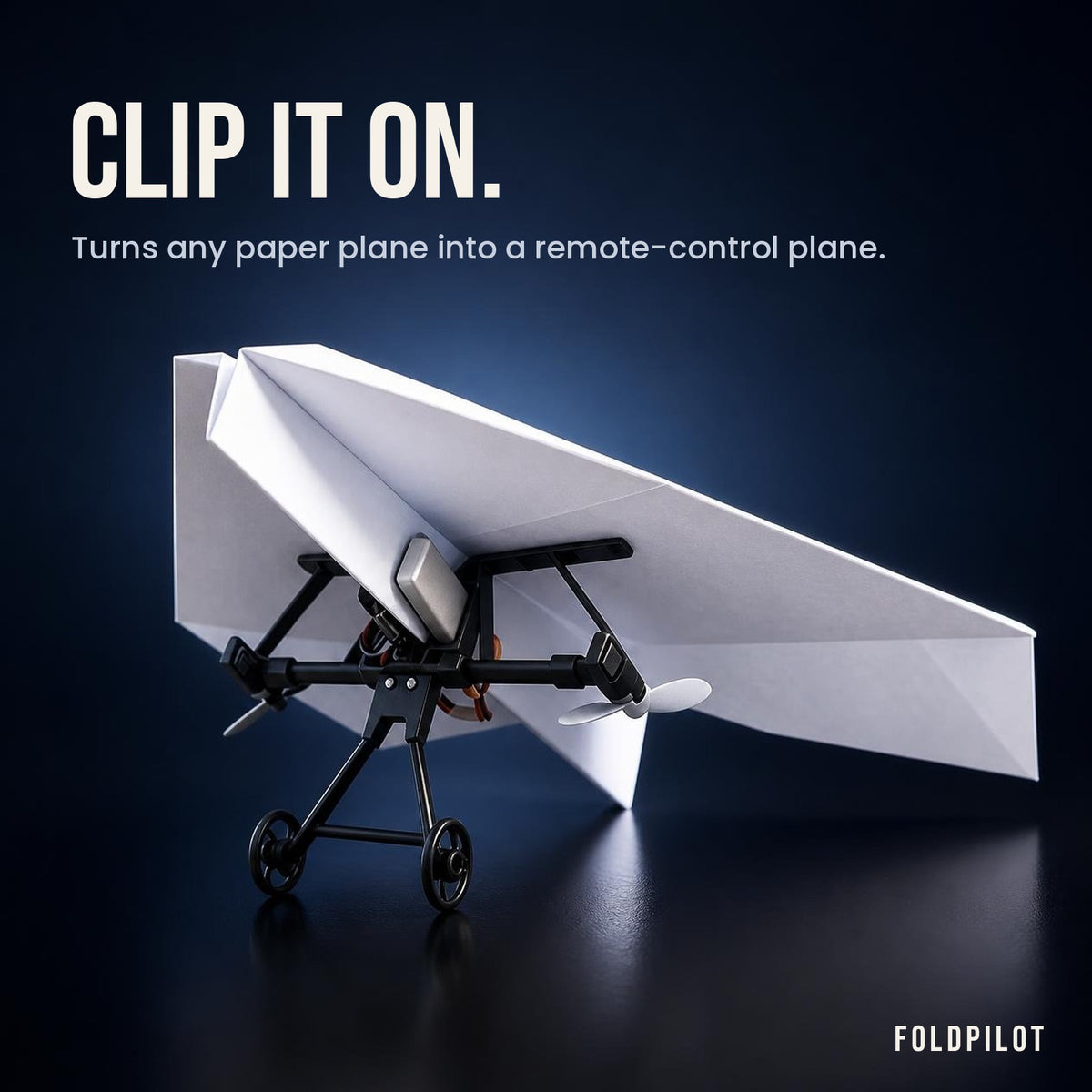 FoldPilot power module clipped onto a paper airplane